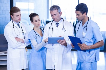 Doctors looking in digital tablet