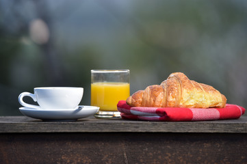 Breakfast coffee, orange juice and croissant
