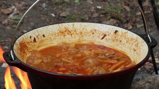 Closeup view of boiling potato stew in hot cauldron