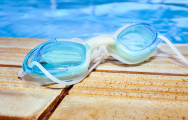Blue modern Swim goggles on the swimming pool, Selective focus and close up image
