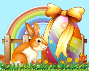 Easter rabbit with egg in the yard
