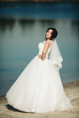 Fototapeta na wymiar Beautiful luxury bride posing with a bouquet outdoors 