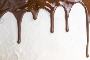 chocolate flowing on a white cake