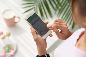 Girl using application on her smartphone to check health