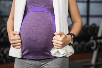 Mid section of pregnant woman standing - Powered by Adobe