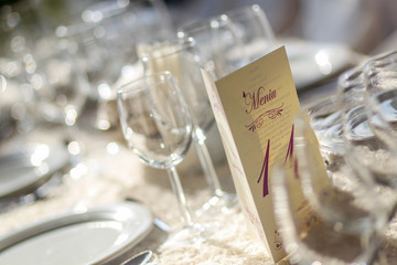 Romantic wedding table arrangement with beige tablecloth and napkins