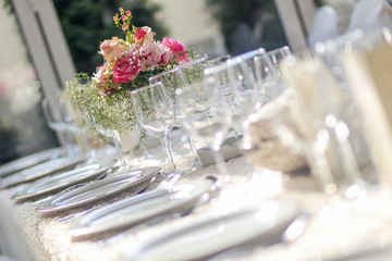 Romantic wedding table arrangement with beige tablecloth