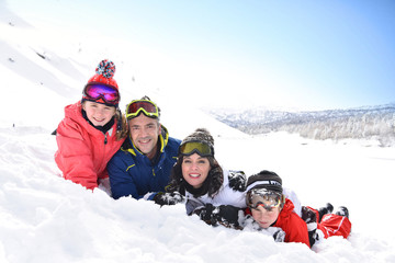 Fototapeta na wymiar Portrait of family having fun in the snow