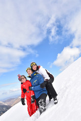 Fototapeta na wymiar Portrait of family having fun walking down snow slope