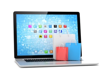 laptop and  shopping pags on white background