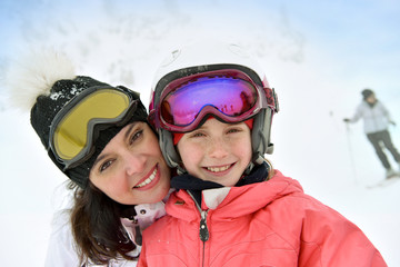 Woman with kid in ski outfit enjoying wintertime © goodluz