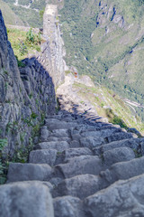 Stone stairs climbing Machu Picchu peak in  Peru