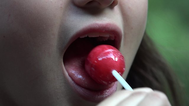 Teen Girl Eating Lollipop