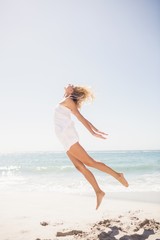 Fototapeta na wymiar Pretty blonde woman jumping