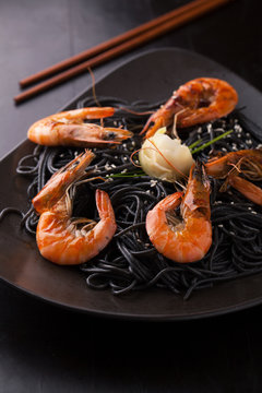 Black spaghetti with shrimps, ginger and sesame seeds