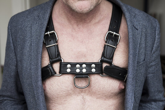 Close-up Of Man's Chest Wearing Leather Harness And Jacket