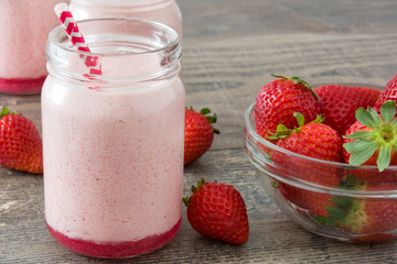 Delicious strawberry smoothie on wood
