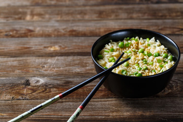 bowl of noodles with vegetables on wood table