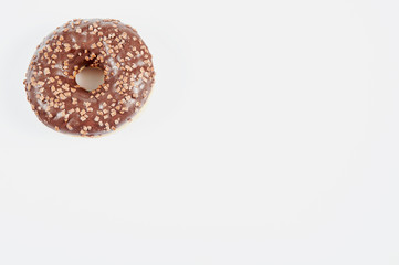Obraz na płótnie Canvas donut / delicious and unhealthy donut lying on a table ready to eat