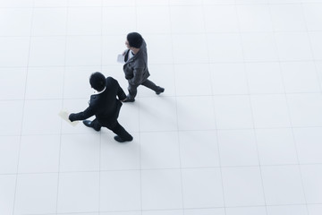 Two business people walking, high angle