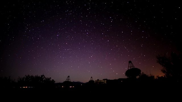 A time lapse of an array of telescopes at an observatory 