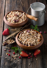 Healthy breakfast of muesli with strawberries, berries, milk and