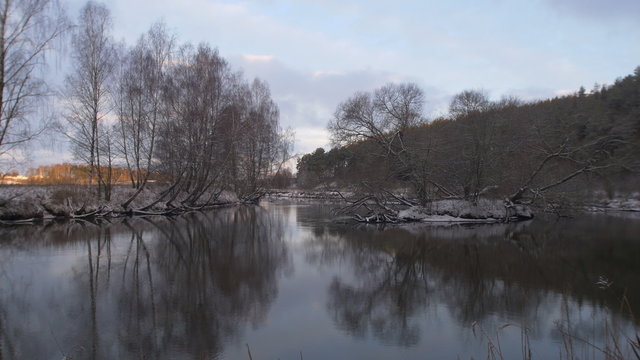 Winter landscape with river and forest.