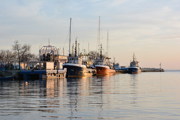 Fototapeta premium Fishing trawlers at sunset