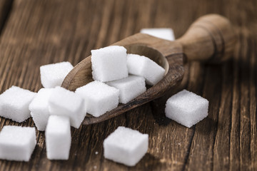 White Sugar (selective focus) on wooden background