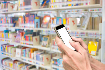 Hands using smartphone in library