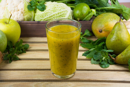 Green fresh smoothie with fruits and vegetables