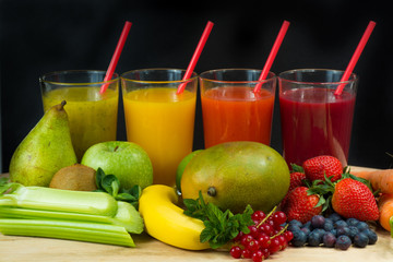 Colofrul fresh pressed fruit juices in tall glasses with fruits