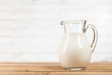 Milk jar on wooden table
