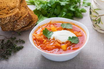 Vegetarian borsch with sour cream and parsley
