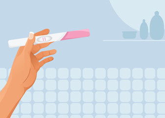 Hand with pregnancy test