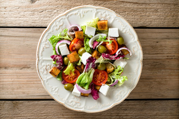 Fresh salad with feta cheese, olives and tomatoes