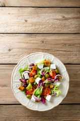 Fresh salad with feta cheese, olives and tomatoes