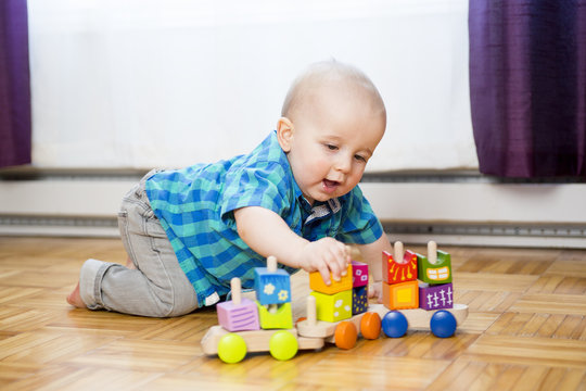 kid toddler playing  wooden toys at home or nursery