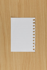 Blank white paper on wood table.