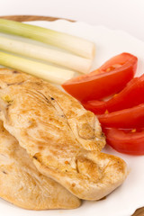 Grilled chicken breast served with tomato salad