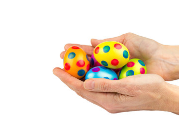 Two hands holding  painted easter eggs isolated on white backgro