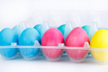 Colorful easter eggs in package isolated.