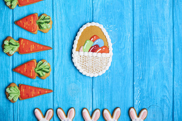 Colorful easter rabbit cookies on blue wooden background