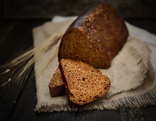 Bread rye spikelets on an wooden background

