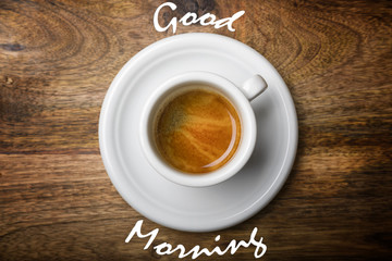 isolated coffee cup top view on wooden background with good morning written