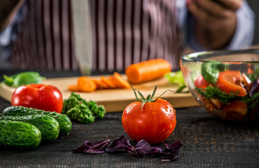 Male hands cutting vegetables for salad