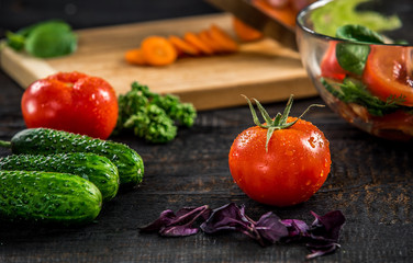 Male hands cutting vegetables for salad