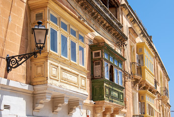 A traditional Maltese townhouses with colorful balconies in Birg