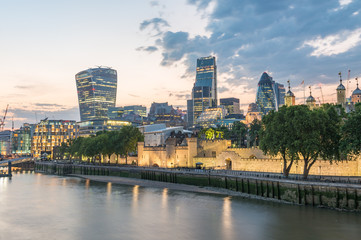 Fototapeta na wymiar London, UK. City buildings along Thames river at dusk