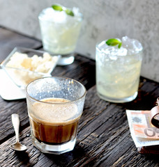 Coffee with milk in a glass on a wooden background